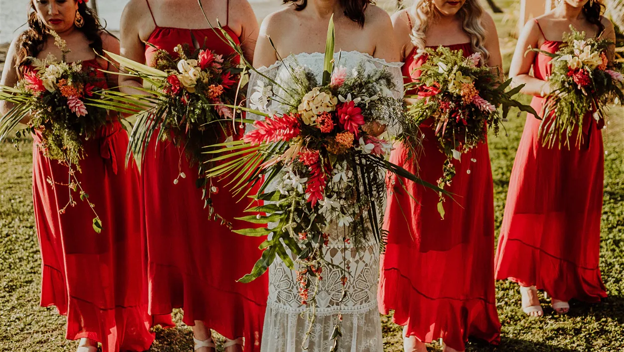 Bridesmaids holding tropical bouquets